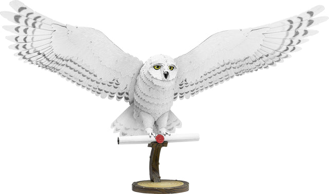 Metal model of Hedwig the owl on a white background