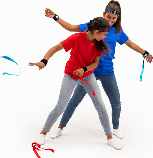 Two people playing Ribbon Ninja Game with ribbons on a white background