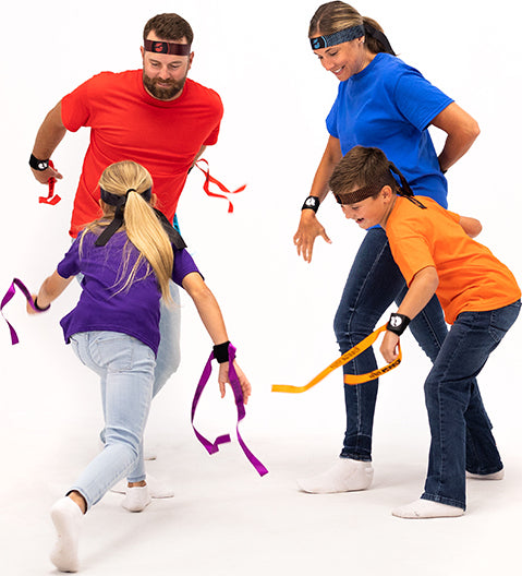 Four people participating in a Ribbon Ninja Game on a white background