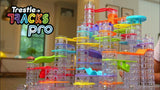 Colorful marble run track set with 'Trestle Tracks Pro' branding in a home setting.