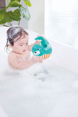 Child playing with a Happy Splashers Seal Jug in a bubble bath