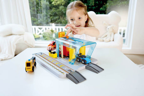 Child playing with a toy Repair & Wash Station set on a table indoors