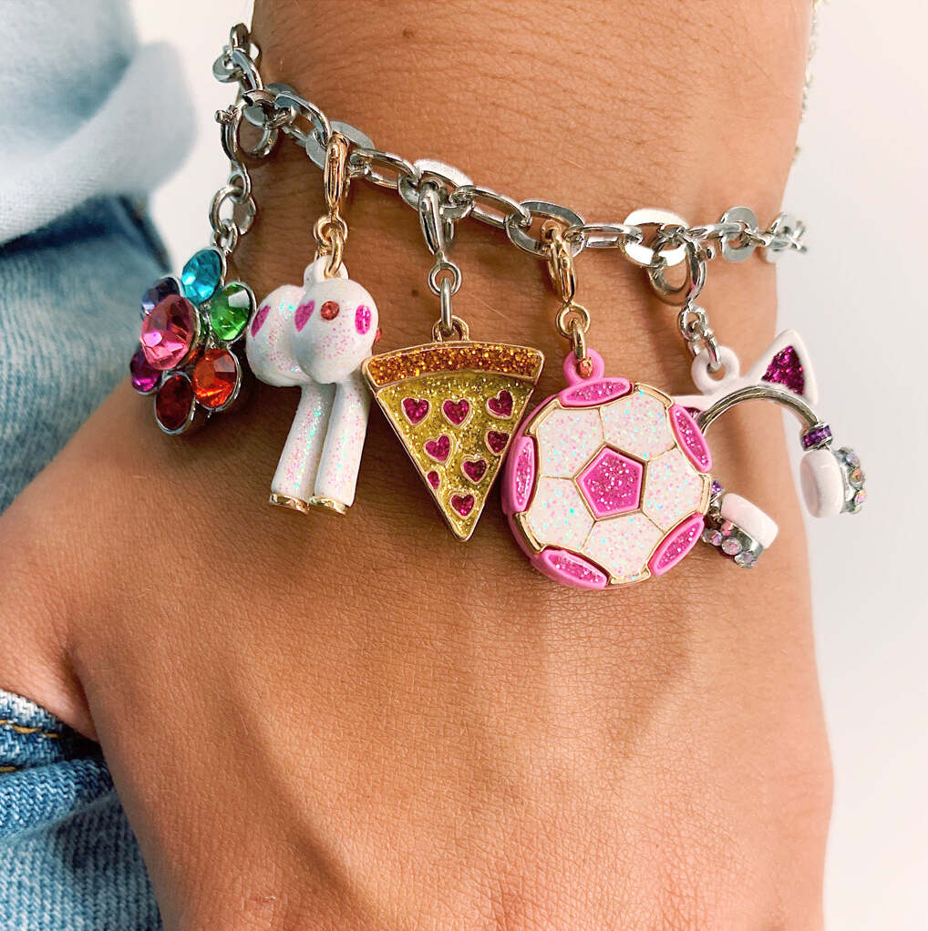 Multicolored charm bracelet on a wrist with various charms.