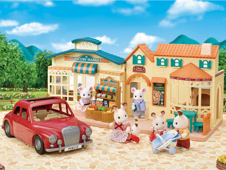 Toy town set with buildings, a Family Cruising Car, and toy figures on a clear day.