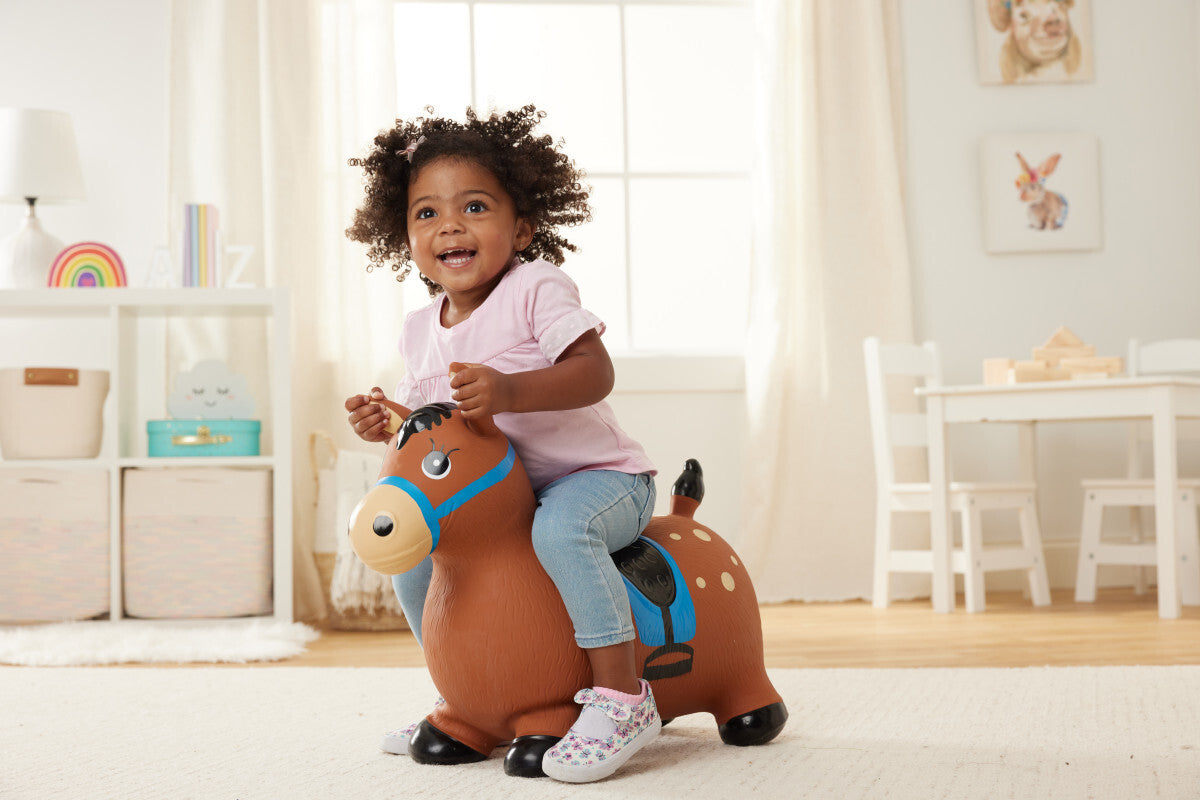 Child riding a Gallop & Go Pony in a bright, well-lit room.