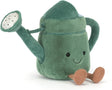 Soft plush watering can toy in shades of green with a smiling face and brown feet, designed as the Amuseables Watering Can for children's imaginative play.