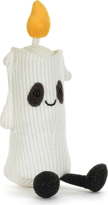 A white Amuseables Flickerty Candle toy with a yellow flame on top, black embroidered eyes and mouth, and black feet, shown on a plain white background.