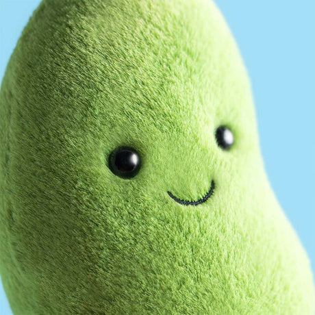 Plush Amuseables Soyella Edamame Bean toy with a smiling face against a blue background