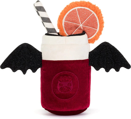 A plush Amuseables Vampop Drink toy featuring a deep red velvet-textured body, white upper section, black bat wings, a black-and-white striped straw, and an orange slice garnish on a white background.