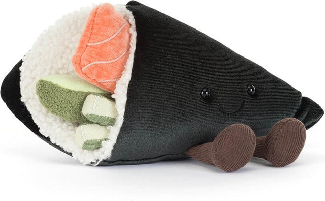 A plush Amuseables Comeroi Temaki shaped like a slice of nigiri sushi, featuring a black fabric exterior, white faux rice, an orange salmon piece, green cucumber pieces, and brown feet, shown on a white background.
