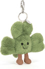 Amuseables Siofra Shamrock Bag Charm featuring a soft green plush shamrock with a smiling face and brown fabric legs, attached to a silver keyring and clip.