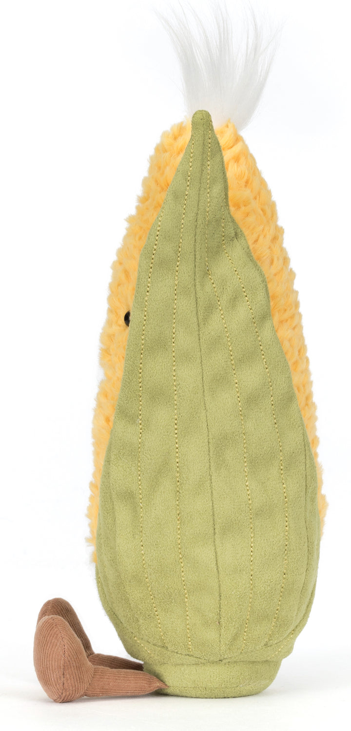 Soft plush Amuseables Sweetcorn toy with textured yellow body, green husk wrapping, and brown corduroy feet, featuring a tuft of white hair on top.