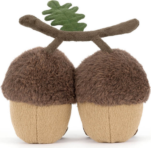 A pair of plushAmuseables Ort & Tum Acorns with fuzzy brown caps, beige textured bodies, and a brown branch with a green leaf on top, shown on a plain white background.