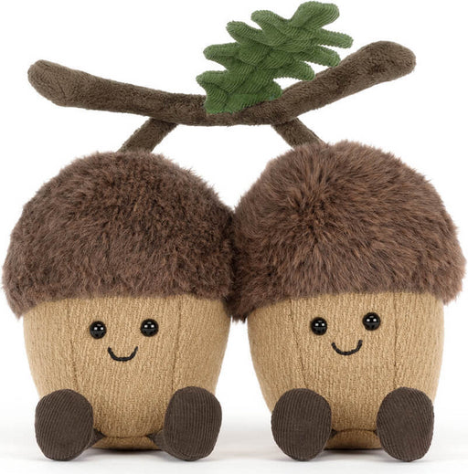 Two plush Amuseables Ort & Tum Acorns toys side by side on a white background. Each acorn has a fuzzy brown cap, a beige textured body, embroidered black eyes and smile, and brown feet.