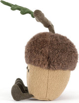 A plush acorn toy with a brown faux-fur cap, a tan textured body, and a green leaf on a stem, photographed on a white background.