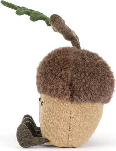 A plush acorn toy with a brown faux-fur cap, a tan textured body, and a green leaf on a stem, photographed on a white background.