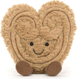 Amuseables Philippe Palmier is a soft, plush toy shaped like a smiling palmier pastry with textured fur and small round feet, perfect for children’s imaginative play.