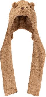 A plush Bartholomew Bear Bundlesnug hooded scarf in a warm tan-brown color, featuring embroidered bear eyes and nose on the hood and long hanging ear flaps, shown against a plain white background.