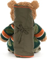 A Bartholomew Bear Hiking Outfit viewed from the back, wearing an olive green backpack over a green, orange, and white striped knit sweater, on a white background.