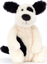 Soft and cuddly Bashful Black & Cream Puppy Small plush toy with black ears, nose, and eye patch, perfect for children as a comforting stuffed animal.