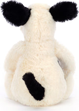 Back view of a soft plush toy Bashful Black & Cream Puppy Small with cream-colored fur, black ears, and a black tail sitting upright.