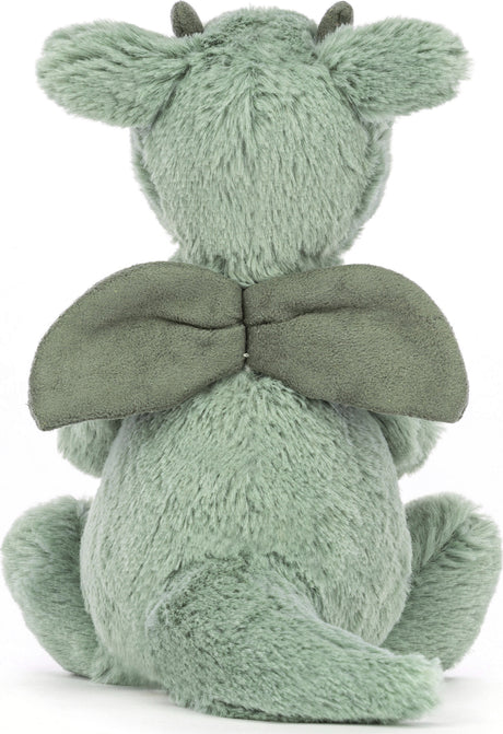 Soft green plush Bashful Dragon Small toy shown from the back, featuring fuzzy fabric, small wings, horns, and a curled tail, perfect as a cuddly stuffed animal for kids.