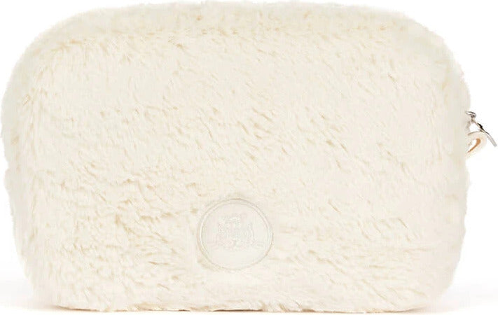 An off-white faux fur Rufferty Puppy Pouchwith a circular embossed logo patch on the front and a silver zipper pull on the right side, shown against a plain white background.