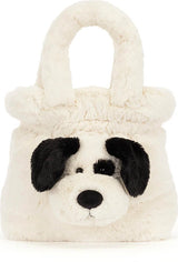 A fluffy faux-fur Rufferty Puppy Handbag shaped like a dog face, featuring black ears, a black nose, and black eye patches on an off-white background, set against a plain white studio backdrop.