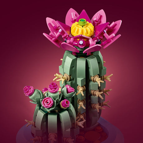 LEGO model of a cactus with pink flowers on a purple background