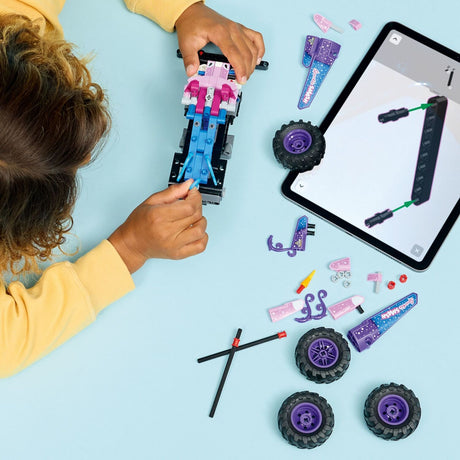 Girl assembling a LEGO Technic: Monster Jam™ Sparkle Smash™ Pull-Back