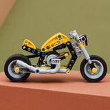 LEGO Technic: Yellow Motorcycle toy made of interlocking bricks on a brown surface with a green background