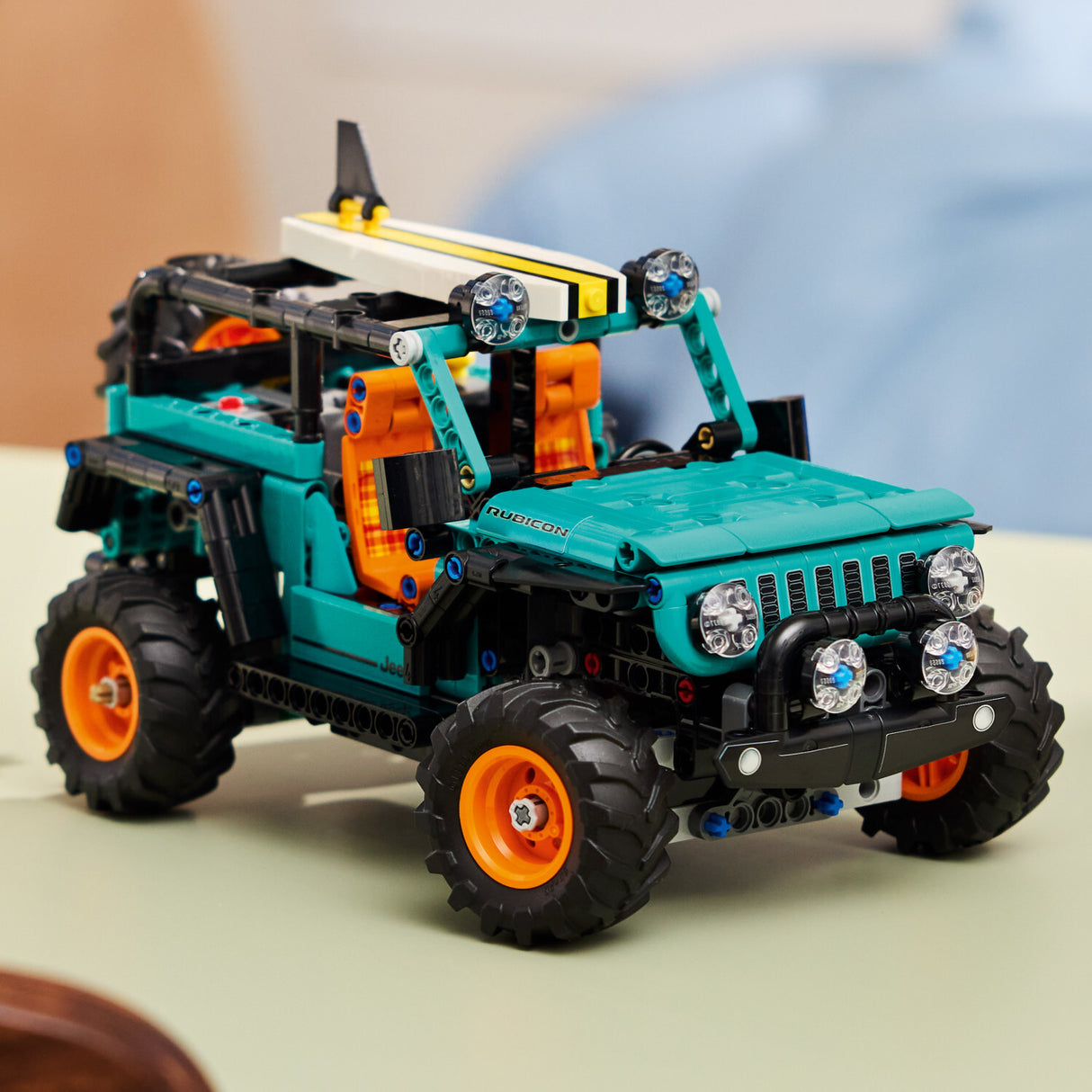 Toy LEGO Technic: Jeep® Wrangler Rubicon SUV model made of interlocking bricks on a neutral background