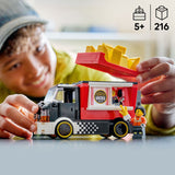 Child playing with a toy LEGO City Great Vehicles: Fries Food Truck and character, with a focus on the product and age recommendation.