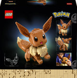 LEGO Pokémon Eevee building set box front, showing a assembled brown and cream Eevee figure on a black background with LEGO and Pokémon branding, smaller product views, a line drawing, and a photo inset of a hand holding the toy.