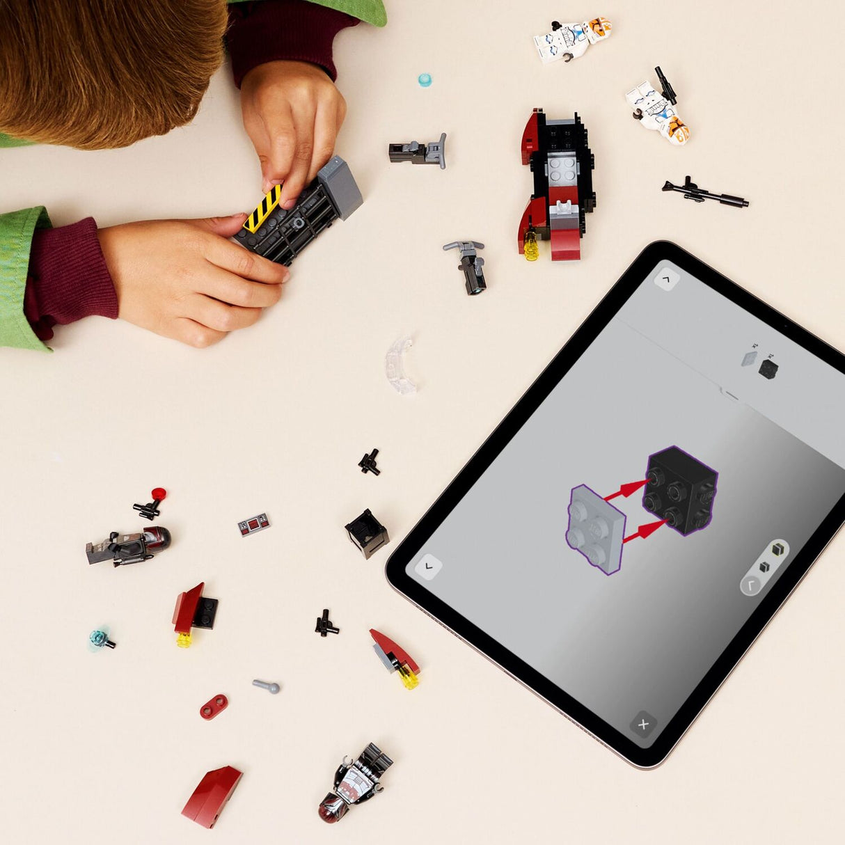 Child building a LEGO Star Wars: Siege of Mandalore Battle Pack
