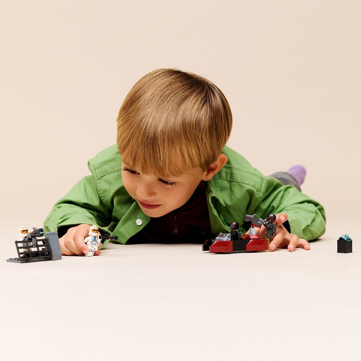 Child playing with a LEGO Star Wars: Siege of Mandalore Battle Pack