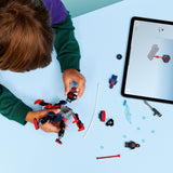 Child building a LEGO Super Heroes Marvel: Miles Morales Mech vs. Spider-Man 2099