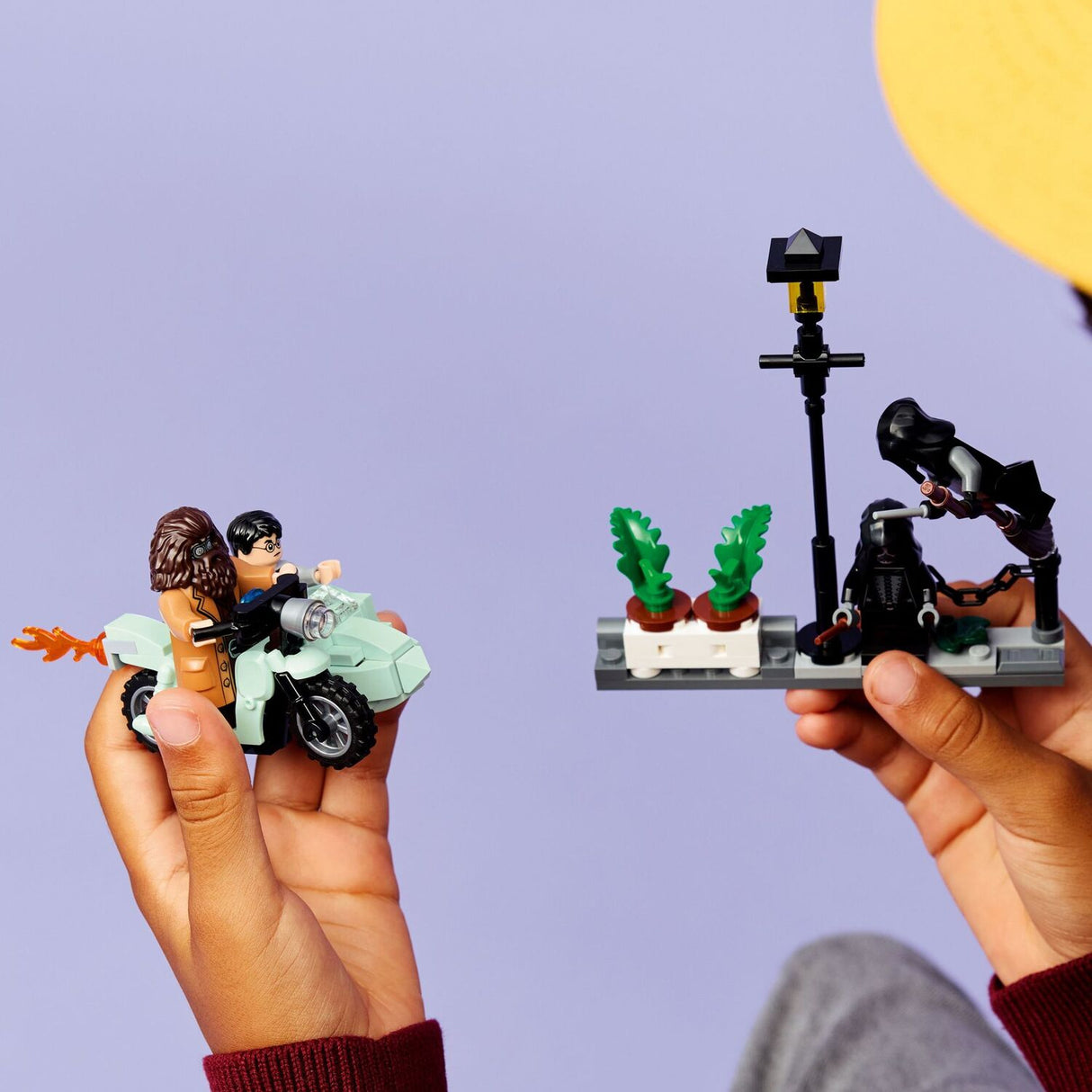 Child holding a LEGO Harry Potter: Hagrid™ & Harry's Privet Drive Escape toy set