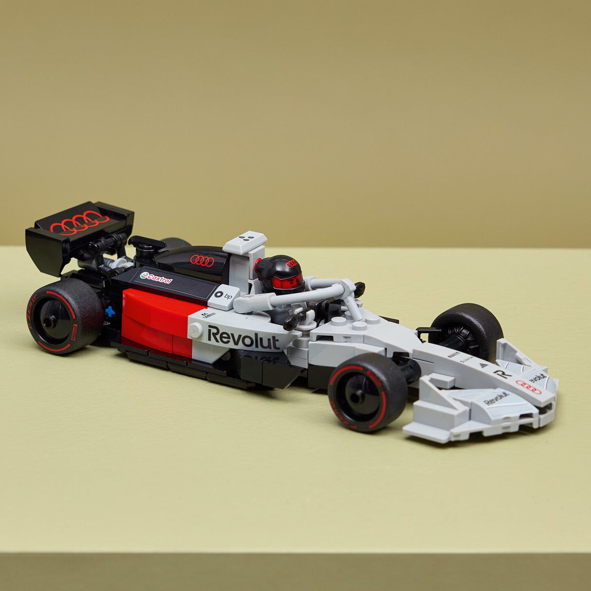 Toy LEGO Speed Champions: Audi Revolut F1® Team R26 Race Car with 'Revolut' branding on a beige background