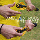 Person using an Bad Rap Travelin Javelin ambidextrous spin dial with text overlay on a grassy background