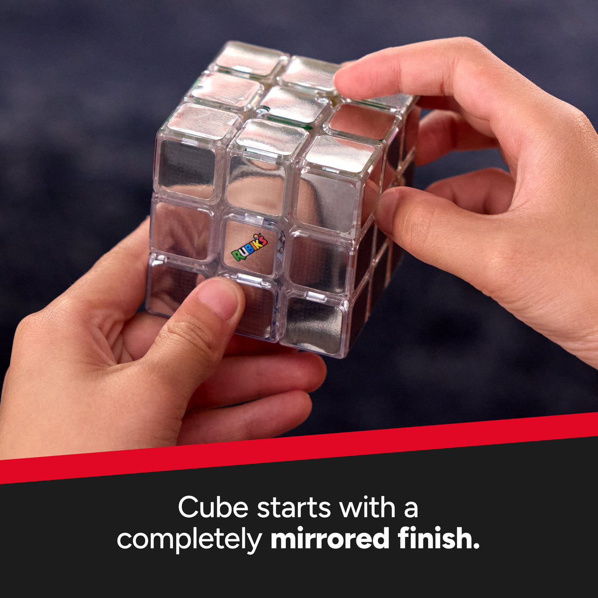 The Official Rubik's Pulse , Person holding a mirrored Rubik's Cube with a dark background