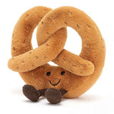 Amuseables Pretzel plush toy with a soft brown texture, friendly smiling face, and small dark feet, designed as a cute and cuddly kid's toy.
