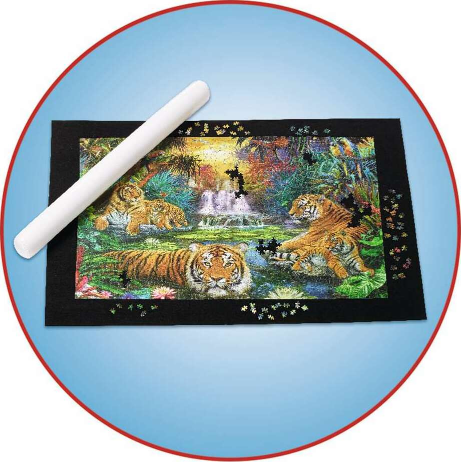 Jigsaw puzzle with tigers on a Roll Your Puzzle XXL , partially completed, on a blue background.