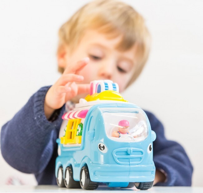 Child playing with a colorful toy Kitty Camper Van on a white background