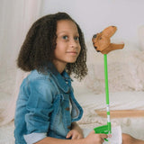 Child holding a Brown T-Rex Snapper Toy against a neutral background