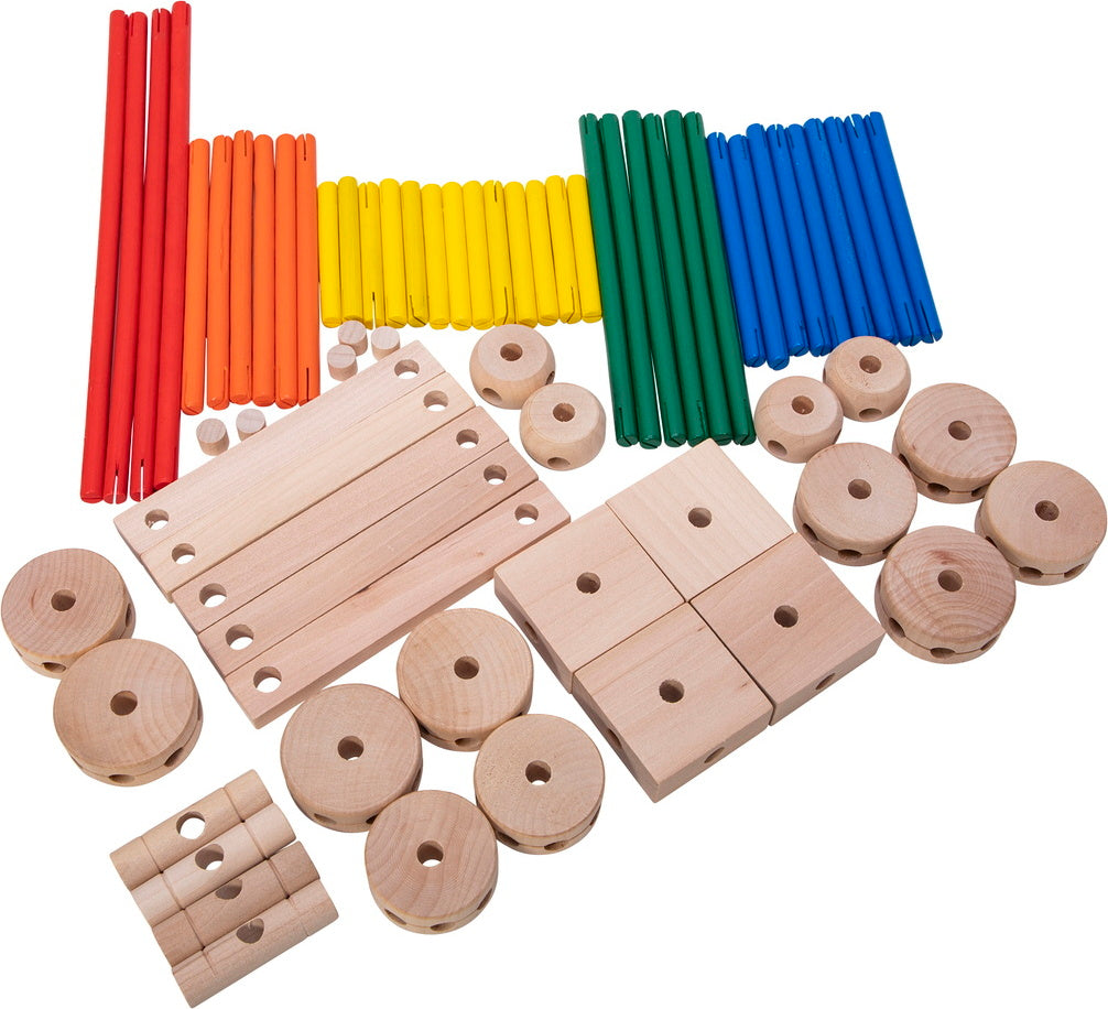 Assorted wooden Makit Toy pieces including rods, blocks, and rings on a white background