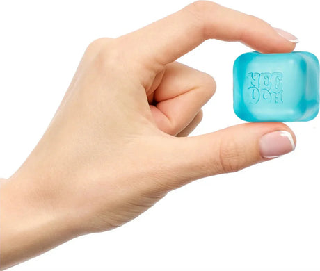 Hand holding a small blue NeeDoh - Nice Ice Baby  on a white background