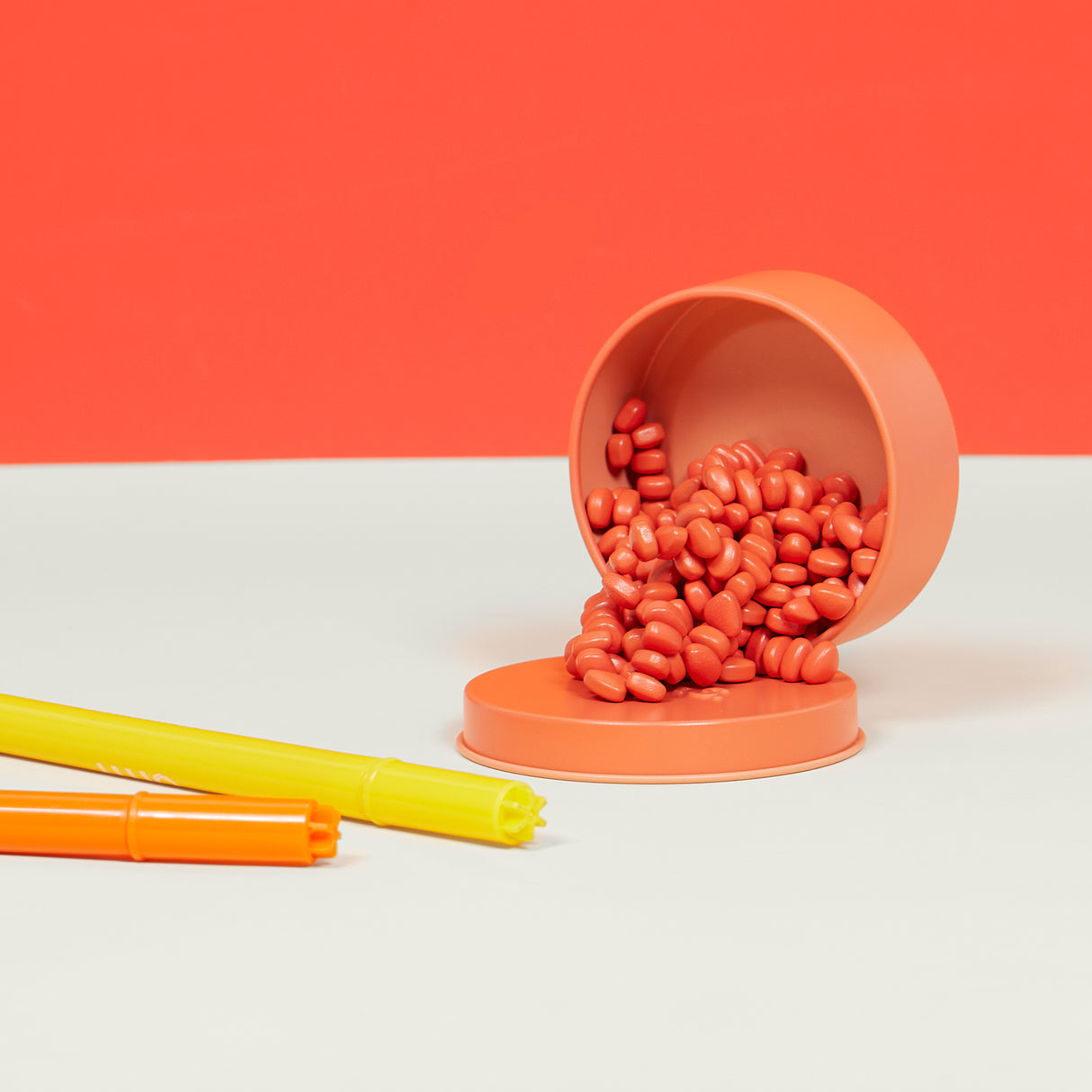 Mini Matte Crags Coral on a white surface with an orange background