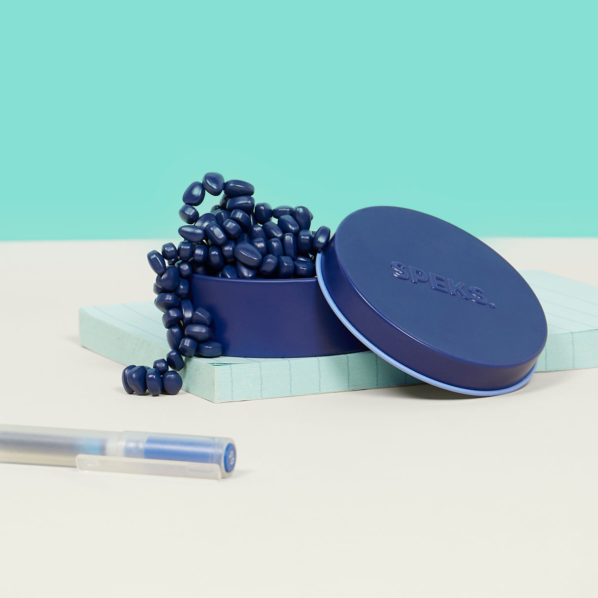 Blue container with lid, Mini Matte Crags Indigo on a light blue background