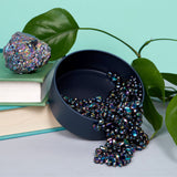 Black Oil Slick container with Medium Crags Oil Slick , books, and green leaves on a light blue background